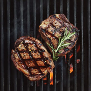 Perfectly Grilled Steaks with Rosemary Garnish