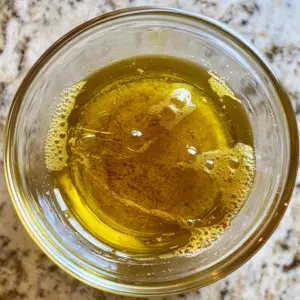 bowl on a countertop filled with a golden, glossy mixture