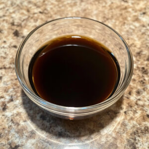 glass bowl of soy sauce