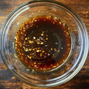 glass mixing bowl containing a marinade
