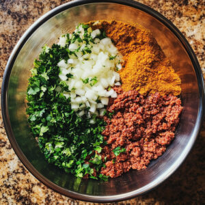large mixing bowl containing the ingredients for beef kofta