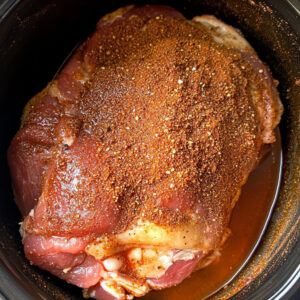 raw pork shoulder, coated in a dry rub
