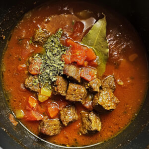 simmering pot filled with a vibrant stew