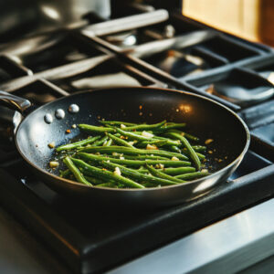 skillet on a stovetop filled with vibrant green beans