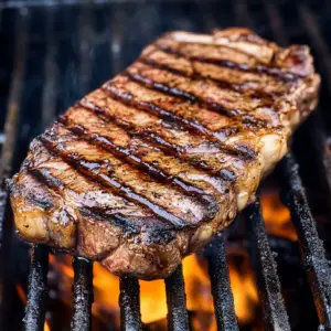 juicy ribeye steak sizzling on a hot grill