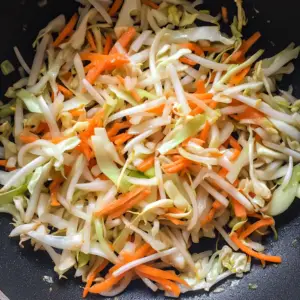 skillet on medium-high heat, filled with fresh, colorful vegetables