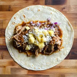 soft flour tortilla laid flat on a wooden surface