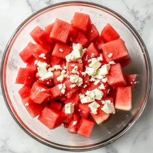 vibrant red watermelon cubes and scattered white crumbles of feta cheese