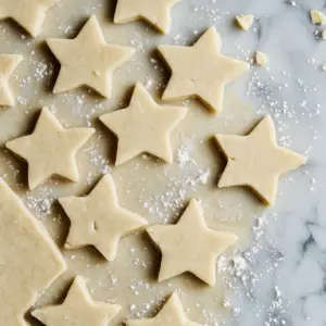 cookie dough rolled out on a flat, lightly floured marble counter
