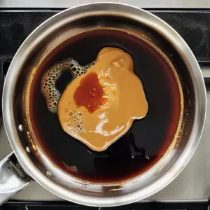 creamy peanut butter, dark soy sauce, deep red sriracha, golden sesame oil, and light broth