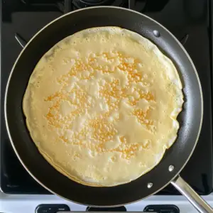 crepe batter spread evenly across the surface