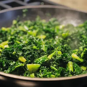 freshly chopped kale being cooked in olive oil