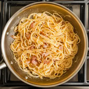 golden, crispy diced pancetta is mixed with long strands of spaghetti
