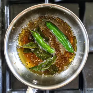 hot ghee sizzling as mustard seeds pop and crackle