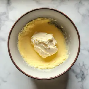 mixing bowl containing a smooth, pale yellow mixture