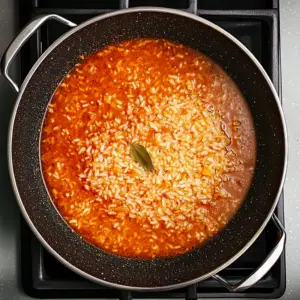 parboiled rice is partially submerged in a vibrant red tomato sauce