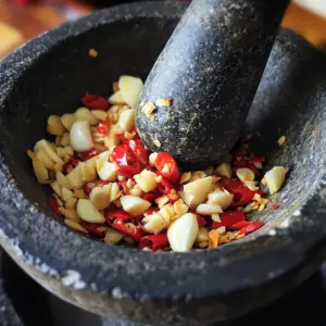 peeled garlic cloves and vibrant red Thai bird's eye chilies