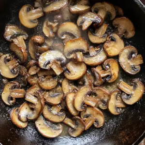 sliced cremini mushrooms sizzling