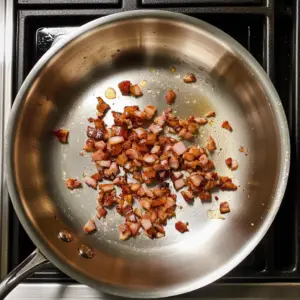small diced pieces of pancetta are sizzling