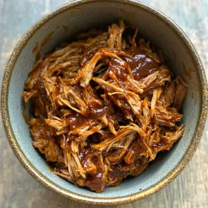 small mixing bowl filled with tender, shredded pulled pork