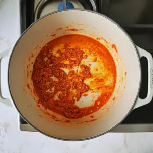 vibrant red Thai curry paste sizzles in hot oil