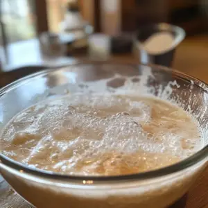 warm water is mixed with sugar and dry yeast