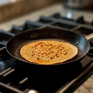 one corn tortilla being warmed