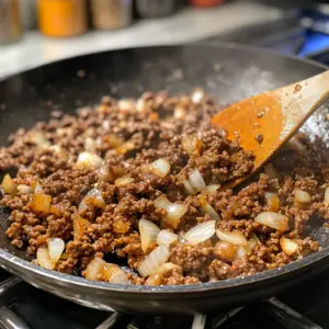 sizzling ground beef that is mostly browned