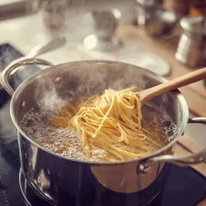 Long strands of uncooked fettuccine pasta